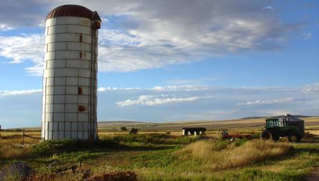 Old silo and farm with a blue sky
